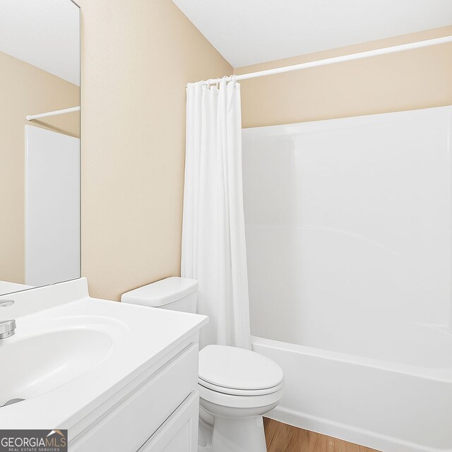 7112 Brookview Way, Riverdale, GA 30274 - bathroom with toilet, wood finished floors, vanity, and shower / bath combination with curtain