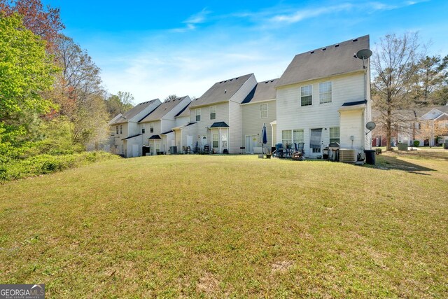7112 Brookview Way, Riverdale, GA 30274 - rear view of house featuring a yard, central AC unit, and a residential view