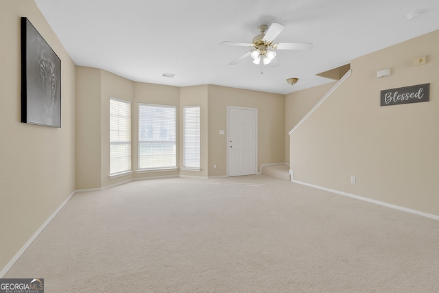 7112 Brookview Way, Riverdale, GA 30274 - unfurnished living room with ceiling fan, visible vents, carpet floors, stairs, and baseboards