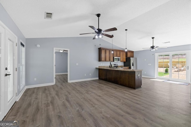348 Bluegill Rd, Eatonton, GA 31024 - kitchen featuring appliances with stainless steel finishes, ceiling fan, vaulted ceiling, open floor plan, and a peninsula