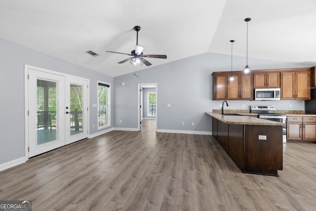 348 Bluegill Rd, Eatonton, GA 31024 - kitchen featuring stainless steel appliances, vaulted ceiling, a peninsula, ceiling fan, and light wood-style floors