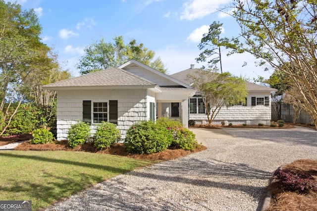 2091 Juliention Dr NE, Townsend, GA 31331 - single story home with a front yard, fence, a shingled roof, and driveway