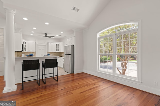 2091 Juliention Dr NE, Townsend, GA 31331 - kitchen featuring glass insert cabinets, a peninsula, ornate columns, light countertops, and stainless steel appliances