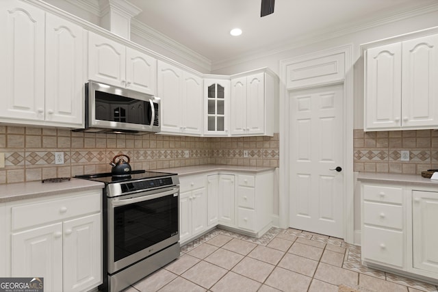 2091 Juliention Dr NE, Townsend, GA 31331 - kitchen with stainless steel appliances, tasteful backsplash, white cabinets, and light countertops