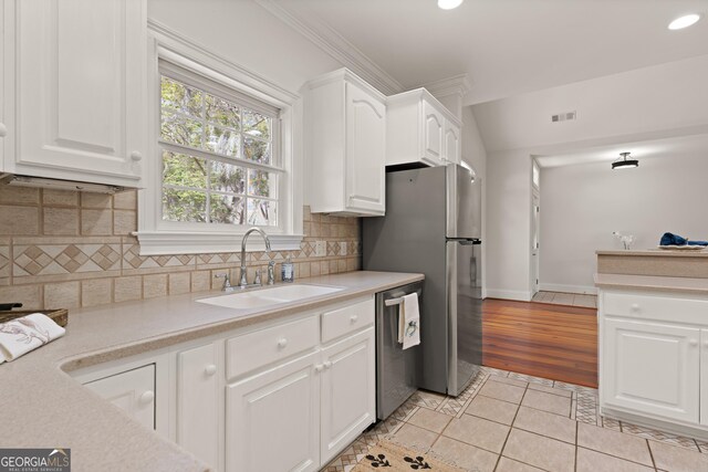 2091 Juliention Dr NE, Townsend, GA 31331 - kitchen with light tile patterned floors, light countertops, visible vents, stainless steel appliances, and a sink