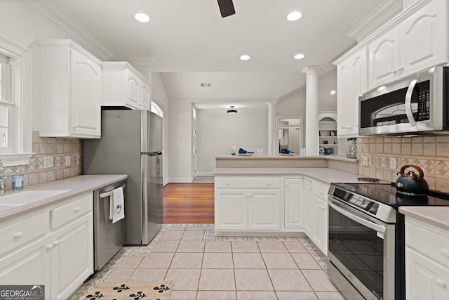 2091 Juliention Dr NE, Townsend, GA 31331 - kitchen with light tile patterned floors, a peninsula, light countertops, white cabinets, and stainless steel appliances