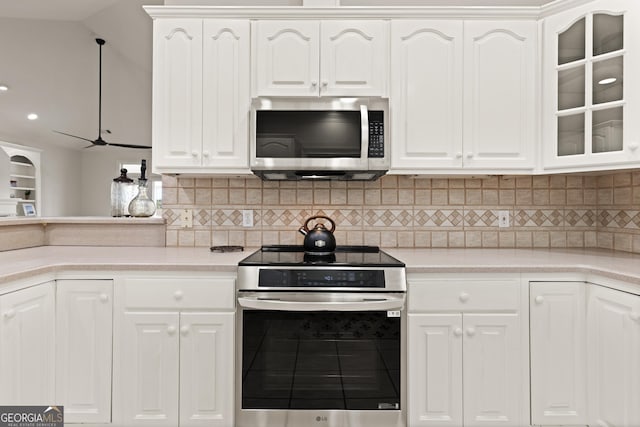 2091 Juliention Dr NE, Townsend, GA 31331 - kitchen featuring tasteful backsplash, glass insert cabinets, light countertops, and appliances with stainless steel finishes