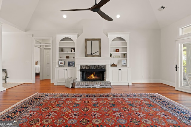 2091 Juliention Dr NE, Townsend, GA 31331 - unfurnished living room featuring visible vents, ceiling fan, built in shelves, and lofted ceiling