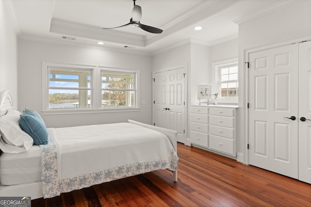 2091 Juliention Dr NE, Townsend, GA 31331 - bedroom featuring ornamental molding, a tray ceiling, multiple closets, and wood finished floors