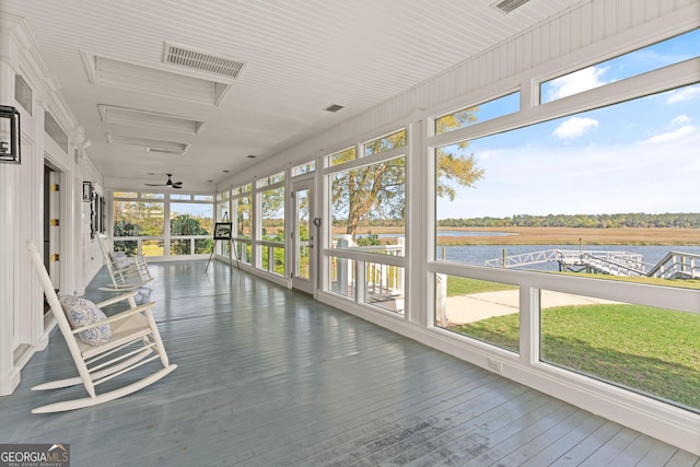 2091 Juliention Dr NE, Townsend, GA 31331 - unfurnished sunroom featuring a water view, visible vents, a wealth of natural light, and wood-type flooring