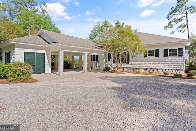 2091 Juliention Dr NE, Townsend, GA 31331 - view of front facade with concrete driveway, an attached carport, and a shingled roof