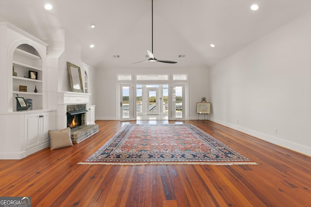 2091 Juliention Dr NE, Townsend, GA 31331 - unfurnished living room featuring wood-type flooring, built in features, ceiling fan, and baseboards