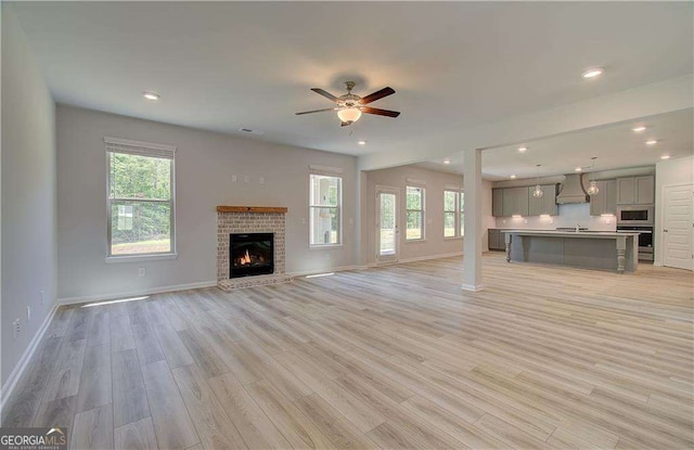 140 Cooper Cv E Lot 21, Fayetteville, GA 30215 - unfurnished living room featuring plenty of natural light, ceiling fan, a fireplace, light wood-style flooring, and recessed lighting