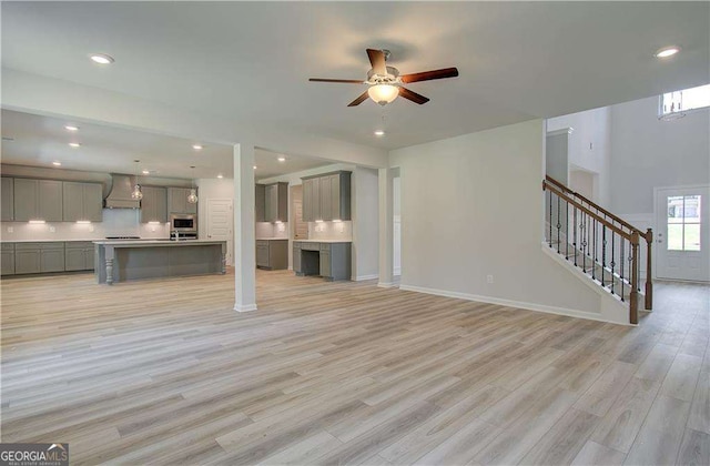140 Cooper Cv E Lot 21, Fayetteville, GA 30215 - unfurnished living room featuring a ceiling fan, light wood-style flooring, stairway, and recessed lighting