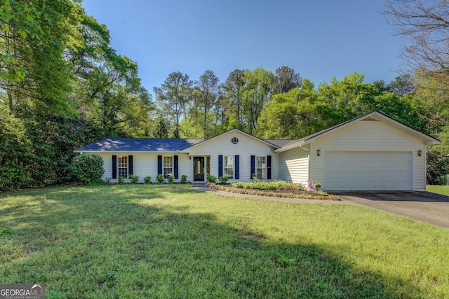 ranch-style house featuring a garage, a front yard, and driveway