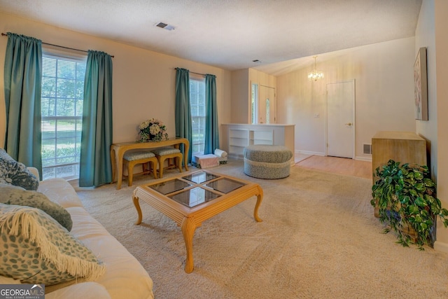 living room featuring visible vents and an inviting chandelier