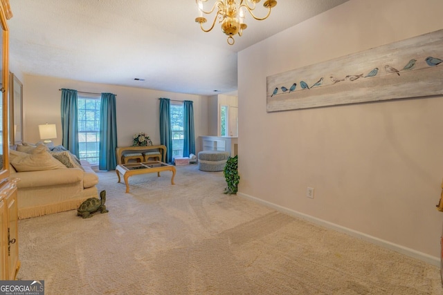 carpeted living room featuring a chandelier and baseboards