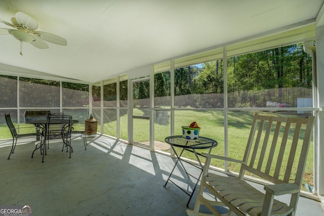 sunroom / solarium featuring a ceiling fan