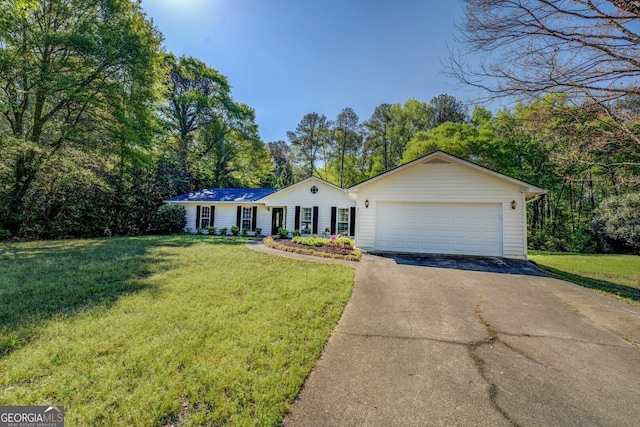 single story home featuring a front yard, an attached garage, and driveway