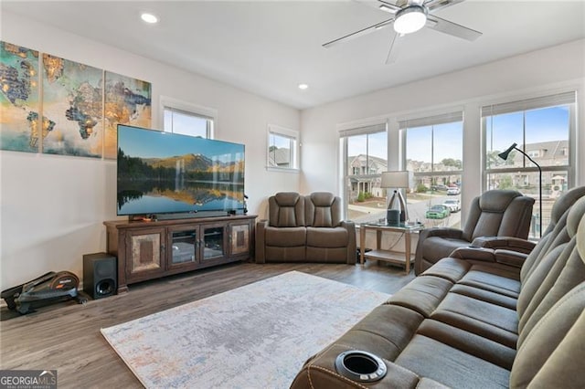 living room with wood finished floors, a ceiling fan, and recessed lighting