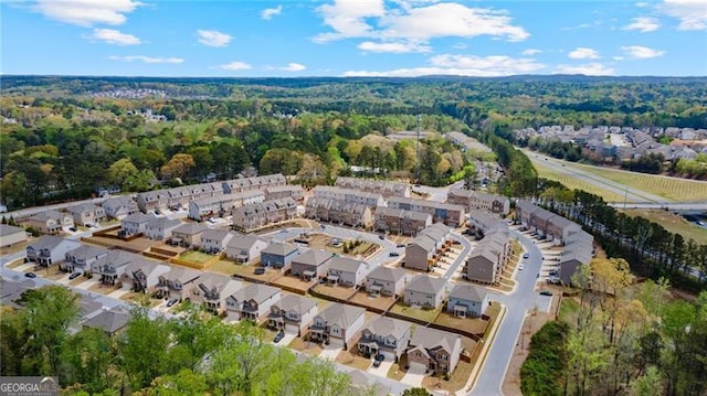 bird's eye view featuring a forest view and a residential view