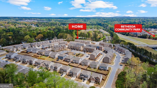 3420 Reagan Way, Lawrenceville, GA 30044 - aerial view of property and surrounding area featuring a heavily wooded area and nearby suburban area