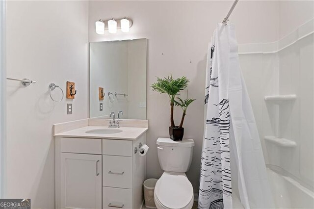 bathroom featuring toilet, shower / bathtub combination with curtain, and vanity