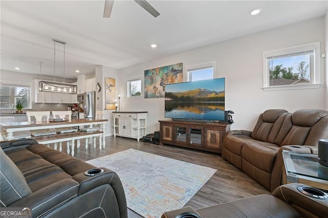 living area with ceiling fan, recessed lighting, and wood finished floors