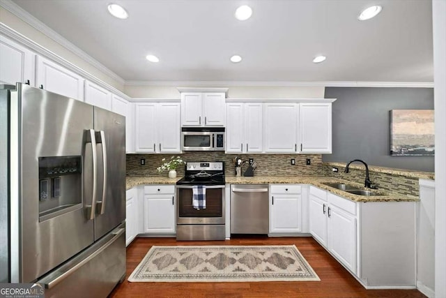 kitchen featuring a sink, white cabinets, dark wood-type flooring, and stainless steel appliances