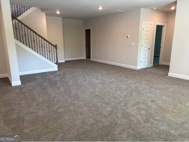 3383 Milan Court Lot 4; Plapprox Sqft 1, Douglasville, GA 30135 - unfurnished living room with carpet flooring, baseboards, stairs, and recessed lighting