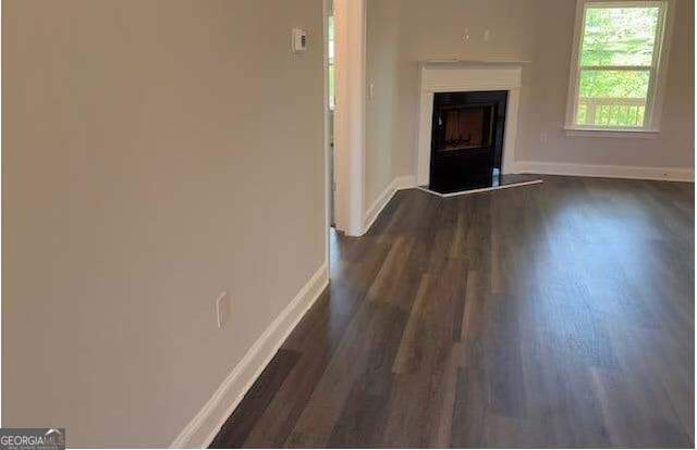 3383 Milan Court Lot 4; Plapprox Sqft 1, Douglasville, GA 30135 - unfurnished living room with baseboards, dark wood finished floors, and a fireplace with raised hearth