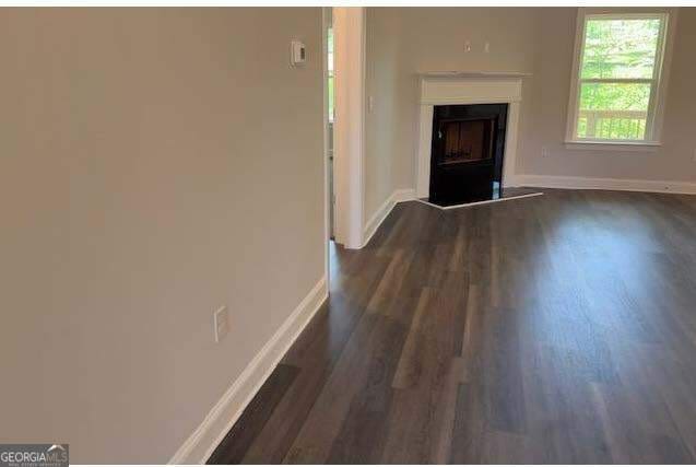 3383 Milan Court Lot 4; Plapprox Sqft 1, Douglasville, GA 30135 - unfurnished living room with dark wood finished floors, baseboards, and a fireplace