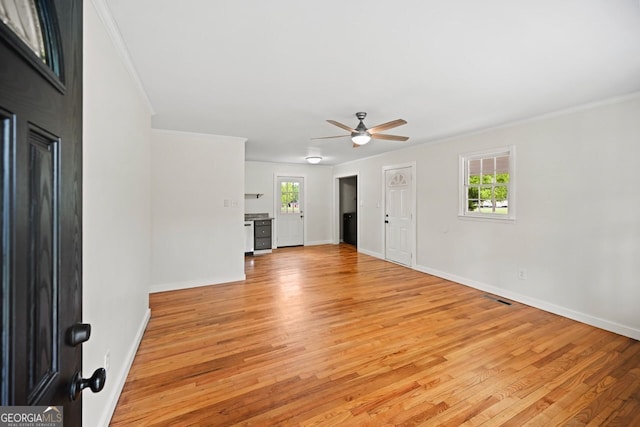 262 E Main St, Rutledge, GA 30663 - unfurnished living room featuring ornamental molding, light wood-style flooring, a ceiling fan, and visible vents