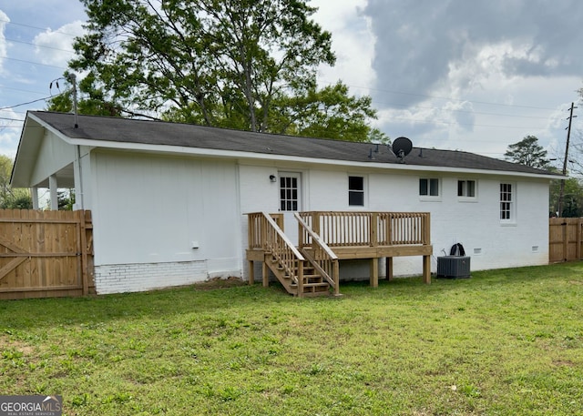 back of house with fence, a yard, crawl space, and a deck