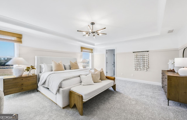 carpeted bedroom with a raised ceiling, a notable chandelier, multiple windows, and visible vents