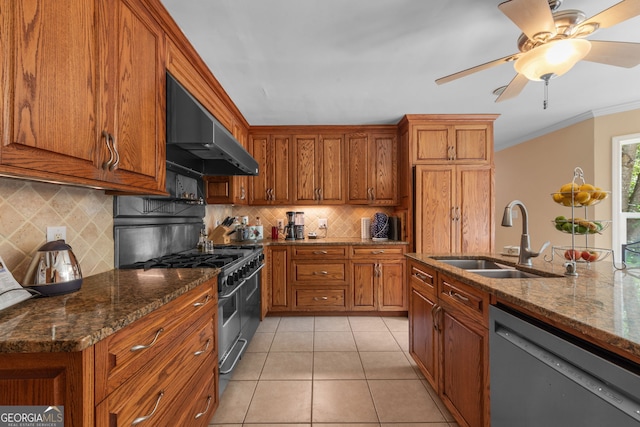kitchen featuring wall chimney range hood, stainless steel appliances, a sink, brown cabinetry, and ornamental molding