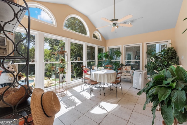 sunroom with tile patterned flooring, plenty of natural light, and high vaulted ceiling