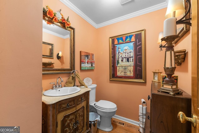 half bath featuring ornamental molding, wood finished floors, vanity, toilet, and baseboards