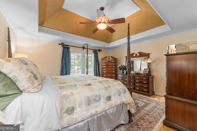bedroom featuring a tray ceiling, crown molding, ceiling fan, and access to outside