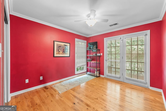 entrance foyer featuring baseboards, wood finished floors, ceiling fan, and ornamental molding
