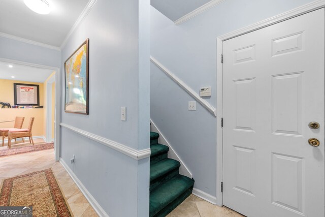 staircase featuring ornamental molding and baseboards