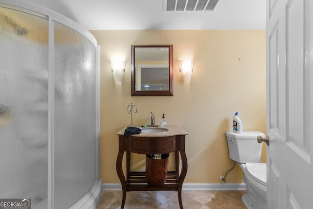 full bathroom featuring a shower stall, toilet, tile patterned flooring, a sink, and baseboards