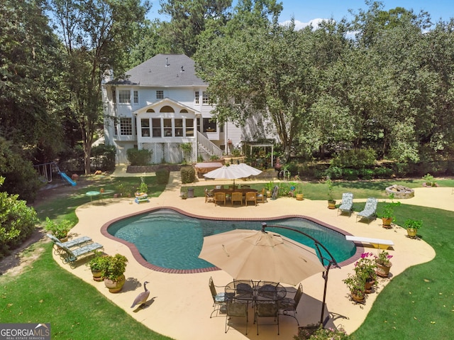 outdoor pool featuring a patio area, outdoor dining area, a lawn, a diving board, and stairs