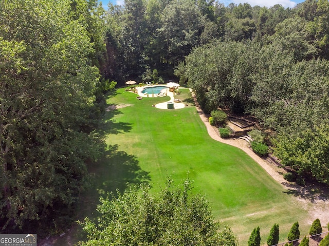 drone / aerial view of a pool area and a forest