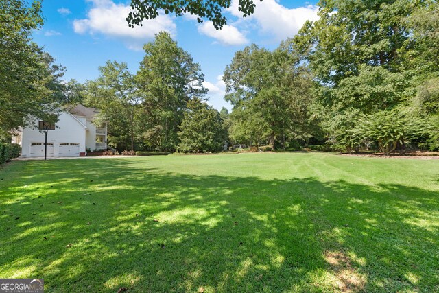 view of grassy yard with an attached garage