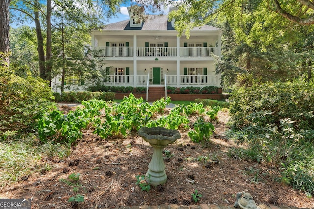 view of front of home featuring a porch, french doors, and roof with shingles