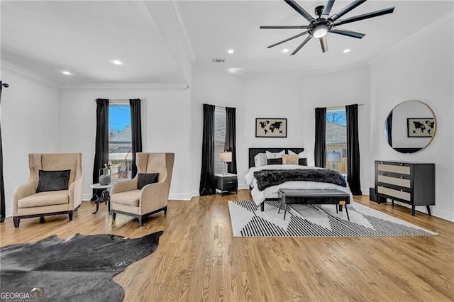 bedroom featuring ornamental molding and multiple windows