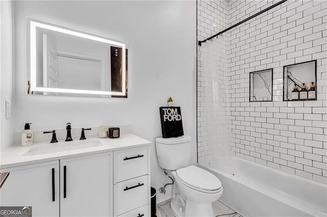 bathroom featuring toilet, vanity, and bathtub / shower combination