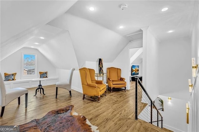 sitting room with recessed lighting, an upstairs landing, wood finished floors, and lofted ceiling