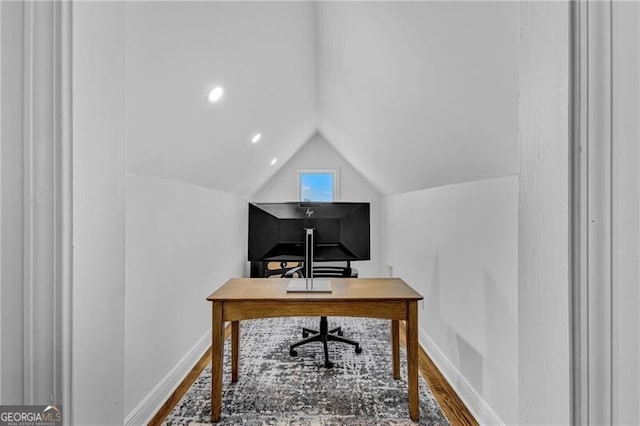 home office with baseboards, vaulted ceiling, and wood finished floors